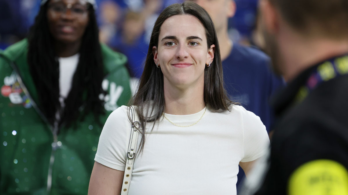 Oct 5, 2025; Indianapolis, Indiana, USA; Caitlin Clark looks on from the sideline during warmups before the game between the Las Vegas Raiders and the Indianapolis Colts at Lucas Oil Stadium. Mandatory Credit: