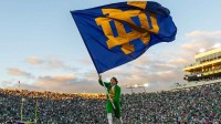 The Notre Dame Leprechaun waves an ND flag after a Fighting Irish touchdown against the NC State Wolfpack during the second half at Notre Dame Stadium.