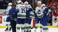 Vancouver Canucks center Filip Chytil (72) is helped off the ice after being injured by a hit from Washington Capitals right wing Tom Wilson (not pictured) during the first period at Capital One Arena.