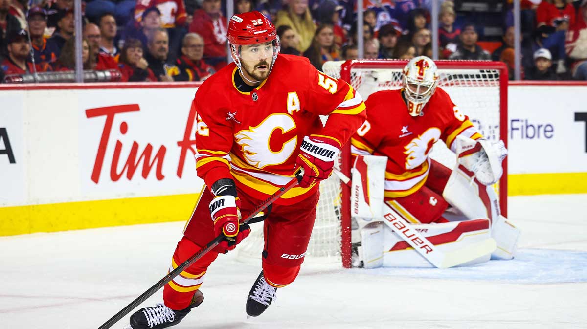 Calgary Flames defenseman MacKenzie Weegar (52) controls the puck against the Edmonton Oilers during the first period at Scotiabank Saddledome.