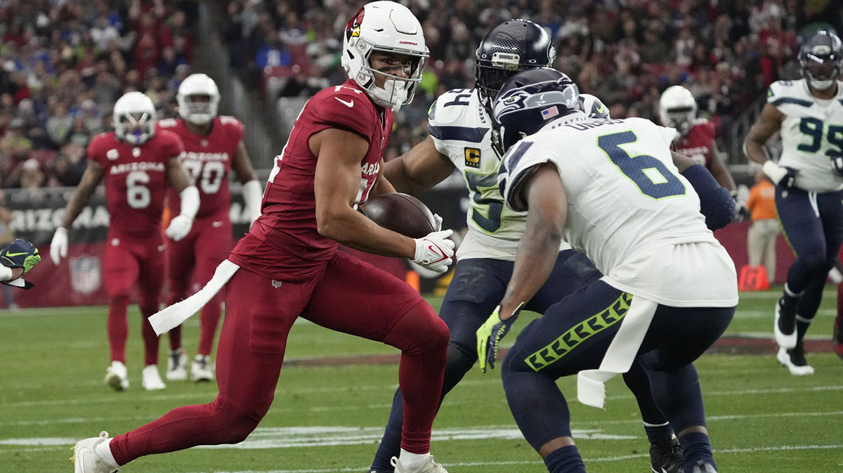 Arizona Cardinals wide receiver Michael Wilson (14) is defended by Seattle Seahawks safety Quandre Diggs (6) after a catch during the second quarter at State Farm Stadium in Glendale on Jan. 7, 2024.