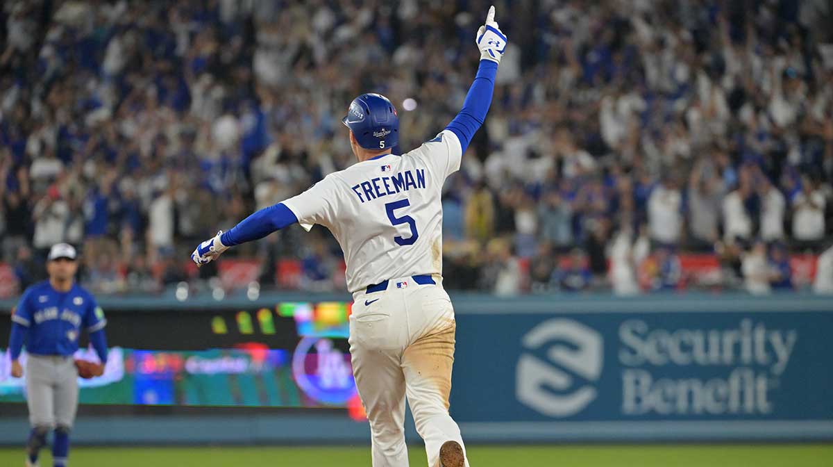 Los Angeles Dodgers first baseman Freddie Freeman (5) celebrates as he runs the bases after hitting a walk off home run against the Toronto Blue Jays in the eighteenth inning during game three of the 2025 MLB World Series at Dodger Stadium.