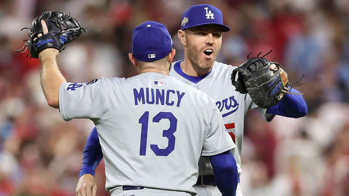 Los Angeles Dodgers third baseman Max Muncy (13) and first baseman Freddie Freeman (5) celebrate after defeating the Philadelphia Phillies in game two of the NLDS round for the 2025 MLB playoffs at Citizens Bank Park.