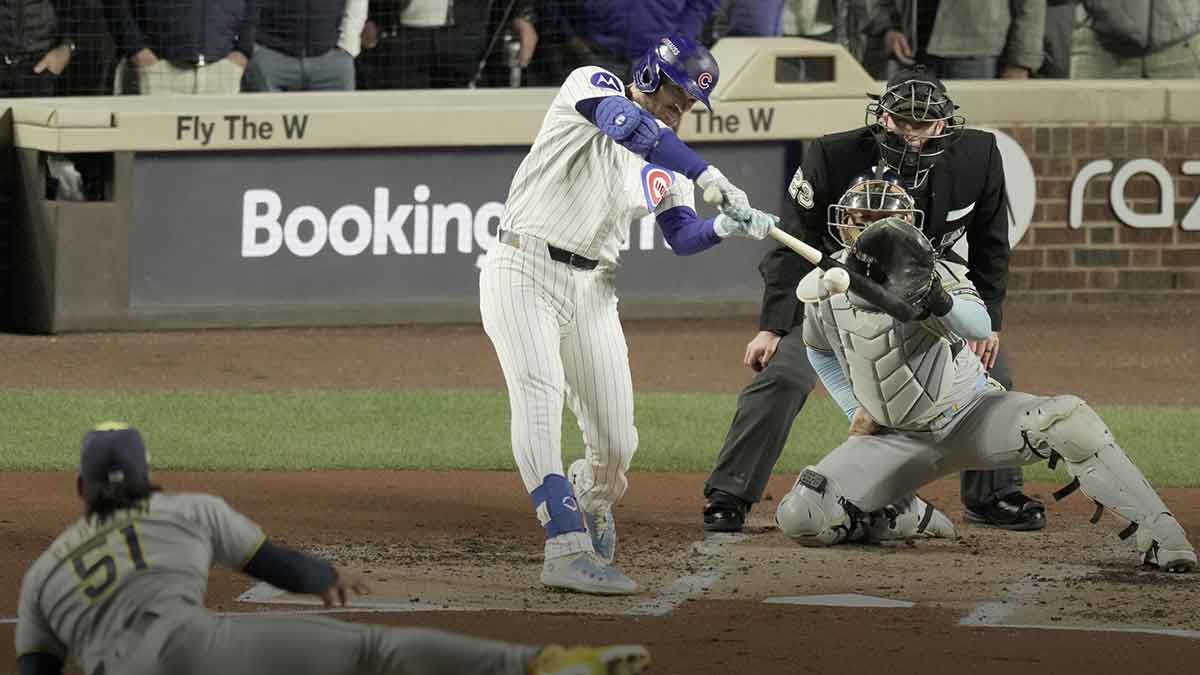 Chicago Cubs left fielder Ian Happ (8) hits a three-run home run off Milwaukee Brewers pitcher Freddy Peralta (51) in the first inning during game four of the NLDS round for the 2025 MLB playoffs at Wrigley Field.