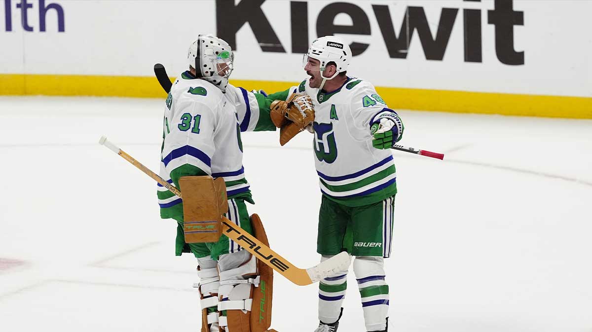 Carolina Hurricanes goaltender Frederik Andersen (31) and left wing Jordan Martinook (48) react after defeating the Colorado Avalanche in a shoot out at Ball Arena.