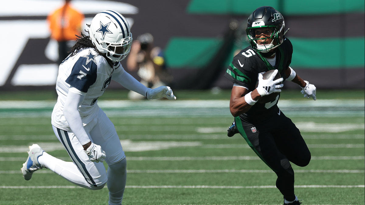 New York Jets wide receiver Garrett Wilson (5) turns up field after the catch as Dallas Cowboys cornerback Trevon Diggs (7) defends during the first half at MetLife Stadium.