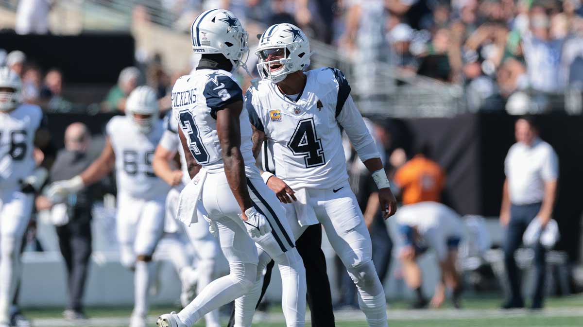 Dallas Cowboys quarterback Dak Prescott (4) reacts with wide receiver George Pickens (3) after throwing a touchdown pass against the New York Jets during the first half at MetLife Stadium.
