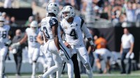 Dallas Cowboys quarterback Dak Prescott (4) reacts with wide receiver George Pickens (3) after throwing a touchdown pass against the New York Jets during the first half at MetLife Stadium.