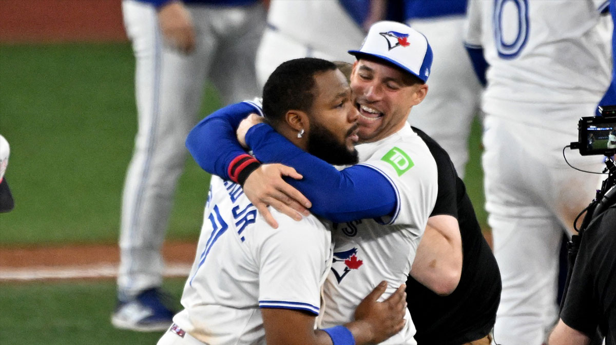 Toronto Blue Jays first baseman Vladimir Guerrero Jr. (27) and designated hitter George Springer (4) celebrate after winning game seven of the ALCS round for the 2025 MLB playoffs against the Seattle Mariners at Rogers Centre.