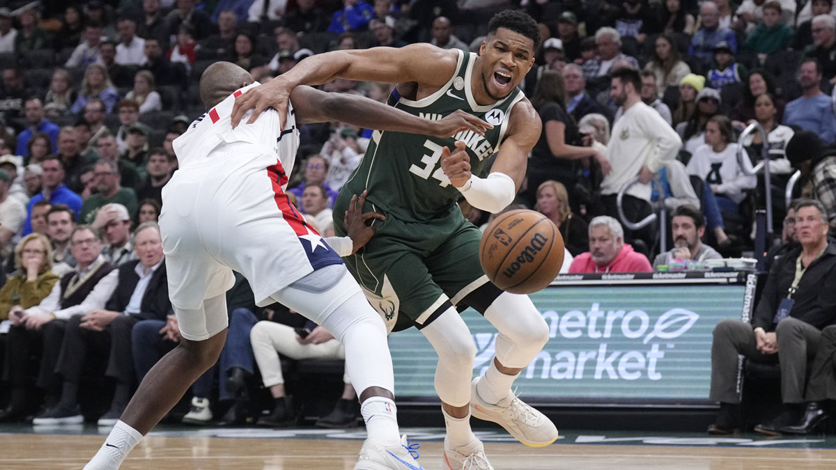 Milwaukee Bucks forward Giannis Antetokounmpo (34) drives against Washington Wizards forward Khris Middleton (22) in the first half at Fiserv Forum.