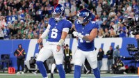 New York Giants quarterback Jaxson Dart (6) and running back Cam Skattebo (44) celebrate Skattebo's touchdown against the Philadelphia Eagles during the second quarter at MetLife Stadium.