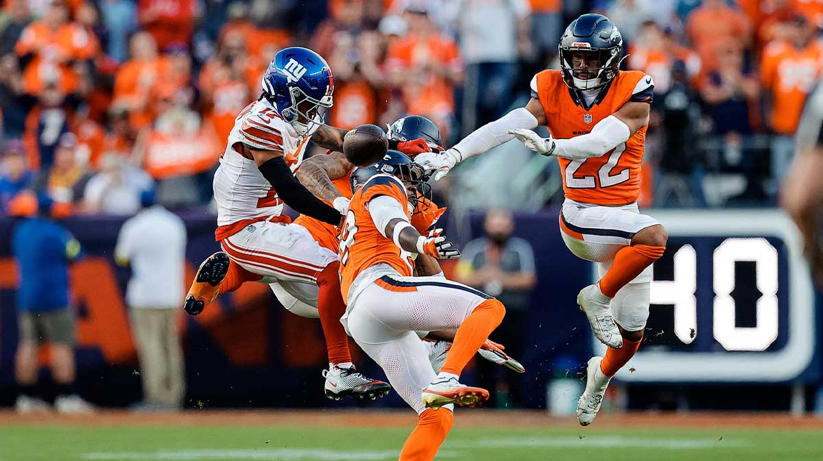 New York Giants wide receiver Wan'Dale Robinson (17) is unable to pull in a pass under pressure from Denver Broncos cornerback Ja'Quan McMillian (29) and cornerback Pat Surtain II (2) defend as safety Brandon Jones (22) defends in the fourth quarter at Empower Field at Mile High. 