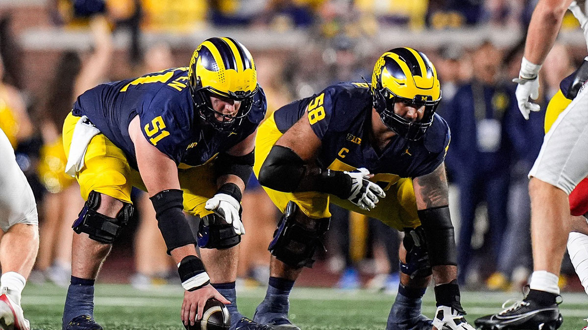 Michigan offensive lineman Greg Crippen (51), center, and offensive lineman Giovanni El-Hadi (58) get ready for a snap against New Mexico during the second half at Michigan Stadium in Ann Arbor on Saturday, August 30, 2025.