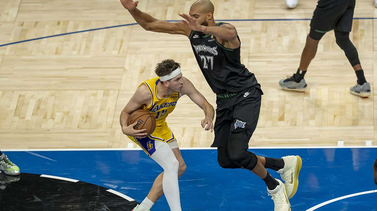 Los Angeles Lakers guard Austin Reaves (15) drives to the basket as Minnesota Timberwolves center Rudy Gobert (27) plays defense in the second half at Target Center