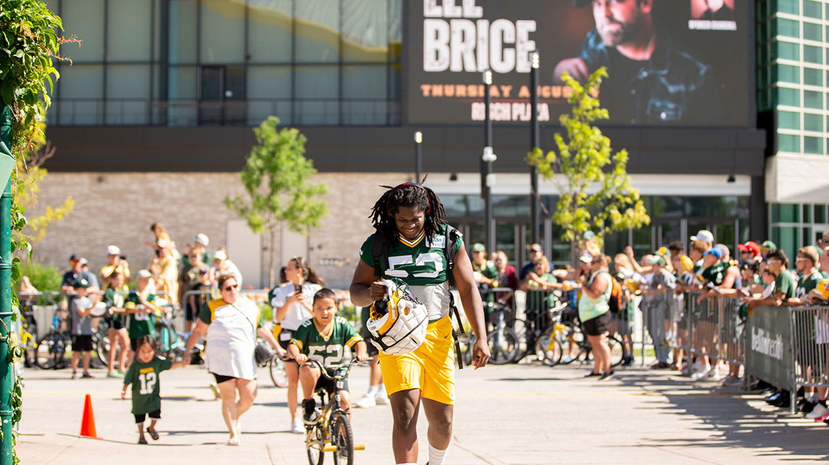 Green Bay Packers linebacker Jonathan Garvin (53) arrives to practice with a big smile during Packers training camp on Thursday, July 28, 2022, at Ray Nitschke Field in Ashwaubenon, Wisconsin.