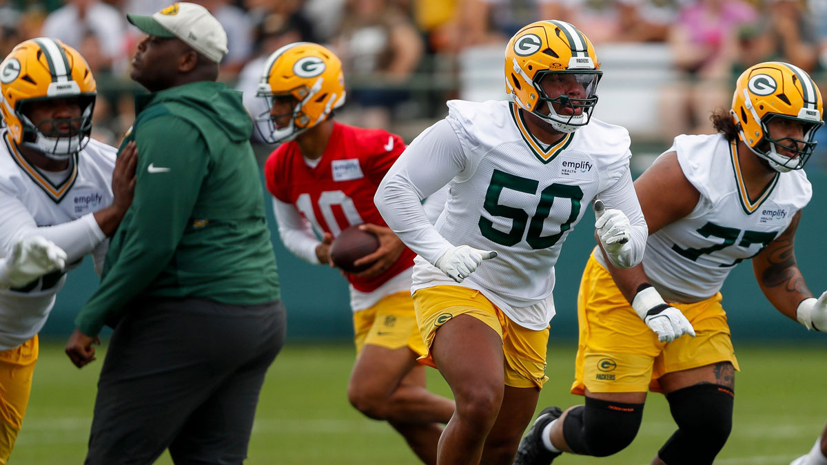 Green Bay Packers offensive tackle Zach Tom (50) runs through a drill during the first day of training camp on Wednesday, July 23, 2025, at Ray Nitschke Field in Ashwaubenon, Wis.