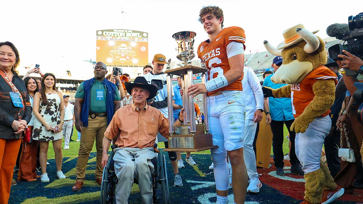 Texas Governor Greg Abbott and Longhorns quarterback Arch Manning, who led them to a Red River Rivalry win one year after Quinn Ewers did the same.