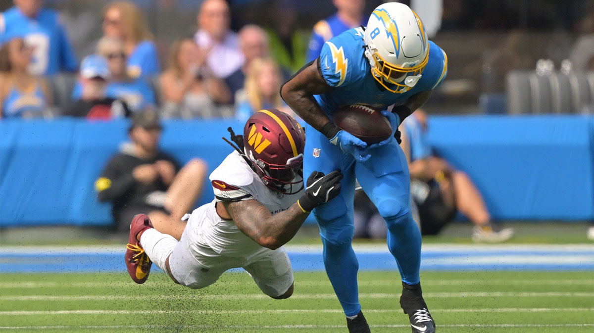 Los Angeles Chargers running back Omarion Hampton (8) makes a catch against Washington Commanders linebacker Frankie Luvu (4) in the first half at SoFi Stadium.