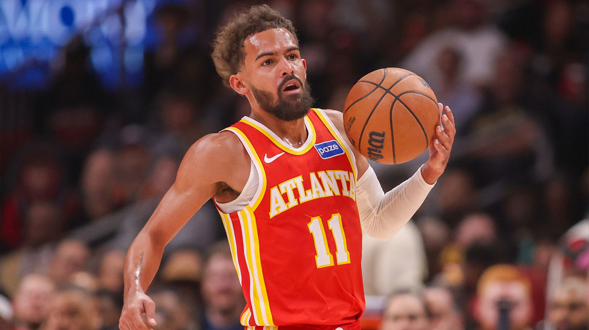 Hawks guard Trae Young (11) dribbles against the Toronto Raptors in the first quarter at State Farm Arena
