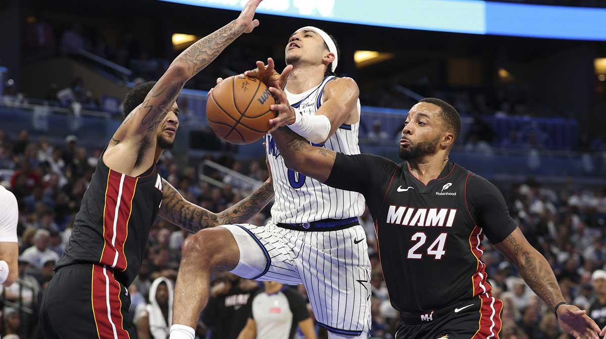 Miami Heat guard Norman Powell (24) strips the ball from Orlando Magic guard Anthony Black (0) in the fourth quarter at Kia Center.