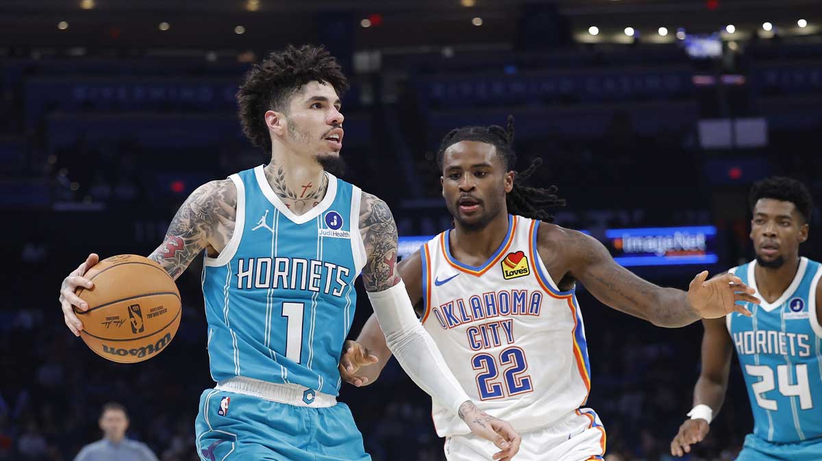 Charlotte Hornets guard Lamelo Ball (1) moves the ball down the court beside Oklahoma City Thunder guard Cason Wallace (22) during the second half of a game between the Charlotte Hornets and the Oklahoma City Thunder at Paycom Center.