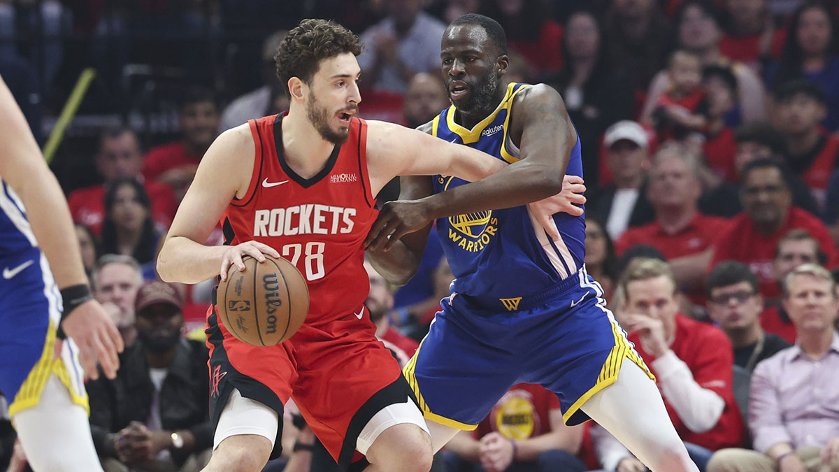 Houston Rockets center Alperen Sengun (28) controls the ball as Golden State Warriors forward Draymond Green (23) defends during the first quarter during game two of the first round for the 2024 NBA Playoffs at Toyota Center.