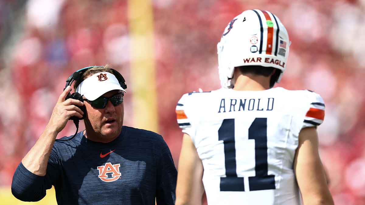 Auburn Tigers head coach Hugh Freeze speaks with Auburn Tigers quarterback Jackson Arnold (11) during the first half against the Oklahoma Sooners.