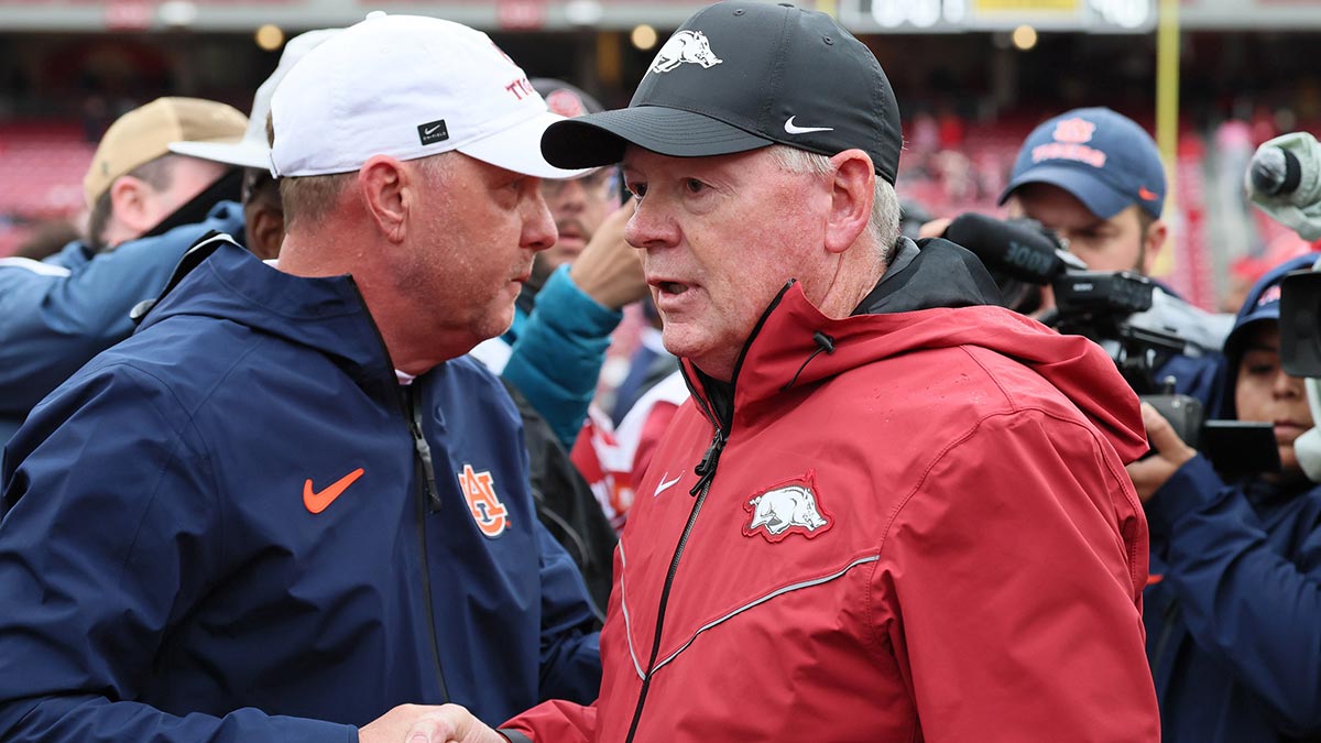 Auburn Tigers head coach Hugh Freeze shakes hands with Arkansas Razorbacks interim head coach Bobby Petrino after the game at Donald W. Reynolds Razorback Stadium. Auburn won 33-24. Mandatory Credit: Nelson Chenault-Imagn Images