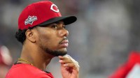 Cincinnati Reds pitcher Hunter Greene (21) watches from the dugout in the eighth inning of the MLB National League Wild Card Game 2 between the Los Angeles Dodgers and the Cincinnati Reds at Dodger Stadium in Los Angeles on Wednesday, Oct. 1, 2025. The Reds were eliminated from the postseason with an 8-4 loss to the reining World Series Champions La Dodgers.