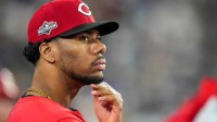 Cincinnati Reds pitcher Hunter Greene (21) watches from the dugout in the eighth inning of the MLB National League Wild Card Game 2 between the Los Angeles Dodgers and the Cincinnati Reds.