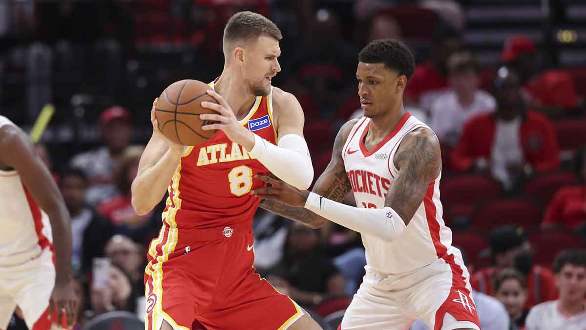 Atlanta Hawks forward/center Kristaps Porzingis (8) controls the ball as Houston Rockets forward Jabari Smith Jr. (10) defends during the first quarter at Toyota Center.