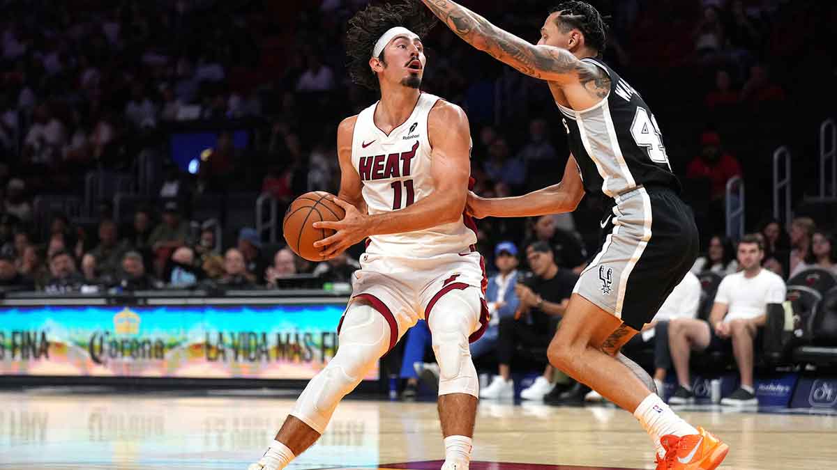 Miami Heat guard Jaime Jaquez Jr. (11) looks to pass the ball as San Antonio Spurs forward Lindy Waters III (43) defends in the first half at Kaseya Center.