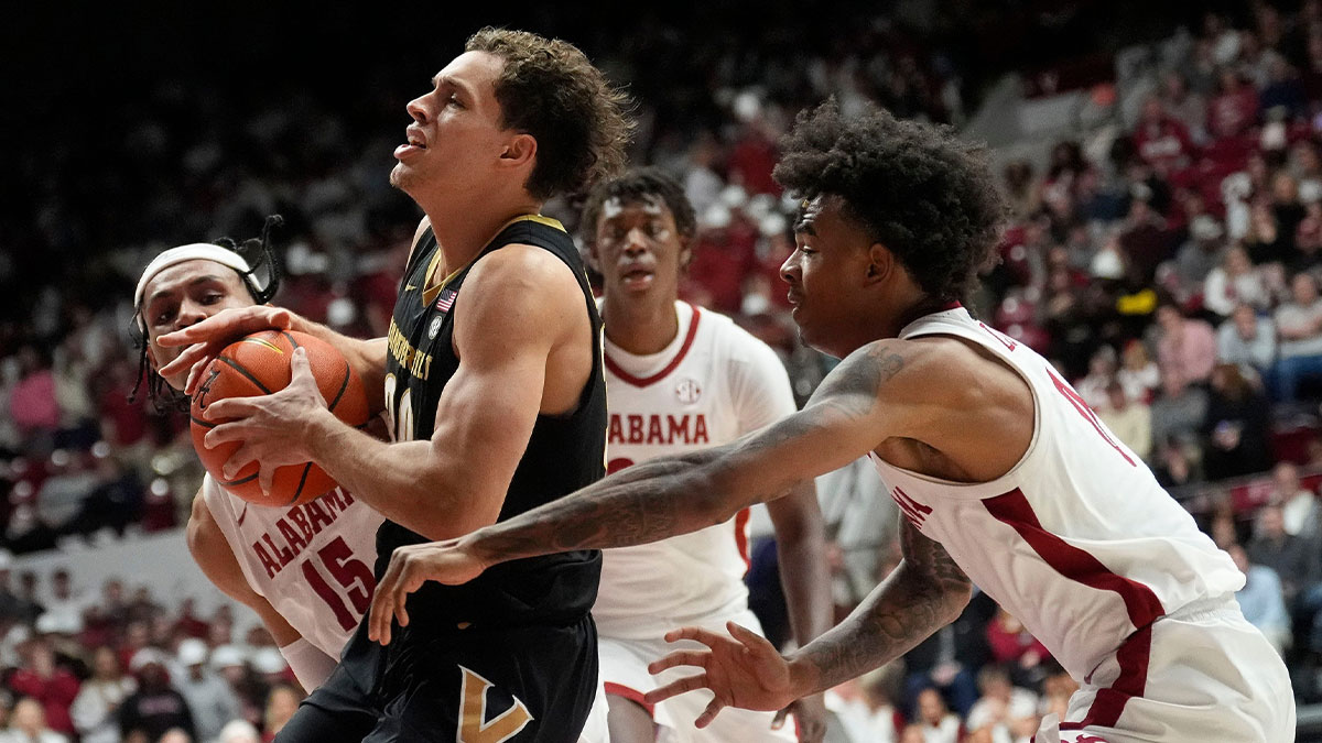 Alabama forward Jarin Stevenson (15) and Alabama guard Labaron Philon (0) fouls Vanderbilt guard Chris Mañon (30) as he drives into the lane at Coleman Coliseum.