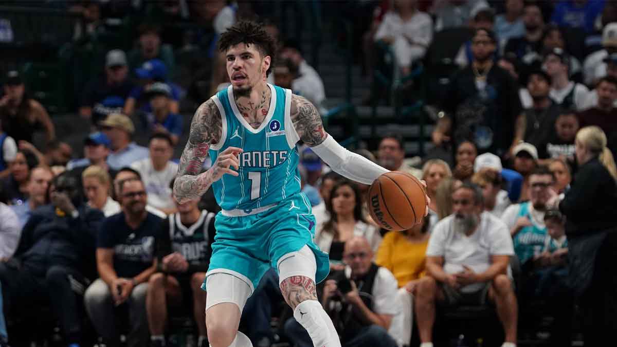 Charlotte Hornets guard Lamelo Ball (1) brings the ball up court against the Dallas Mavericks in the first half of a game at American Airlines Center.