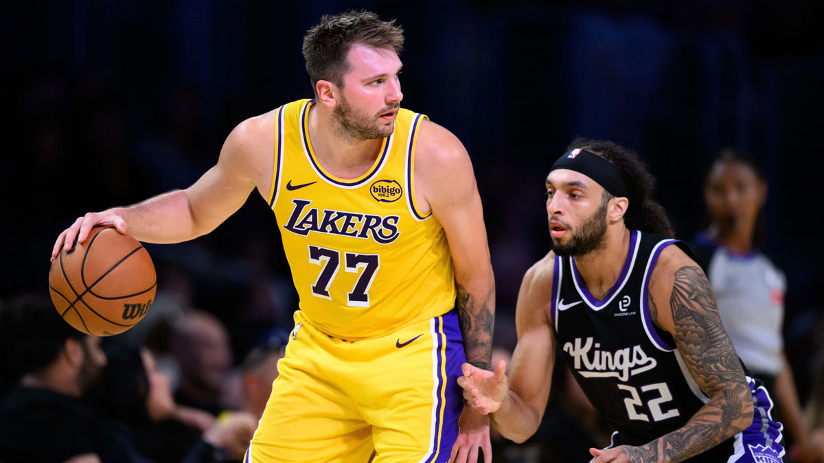Los Angeles Lakers guard Luka Doncic (77) looks to drive the ball against Sacramento Kings guard Devin Carter (22) during the first half at Crypto.com Arena.