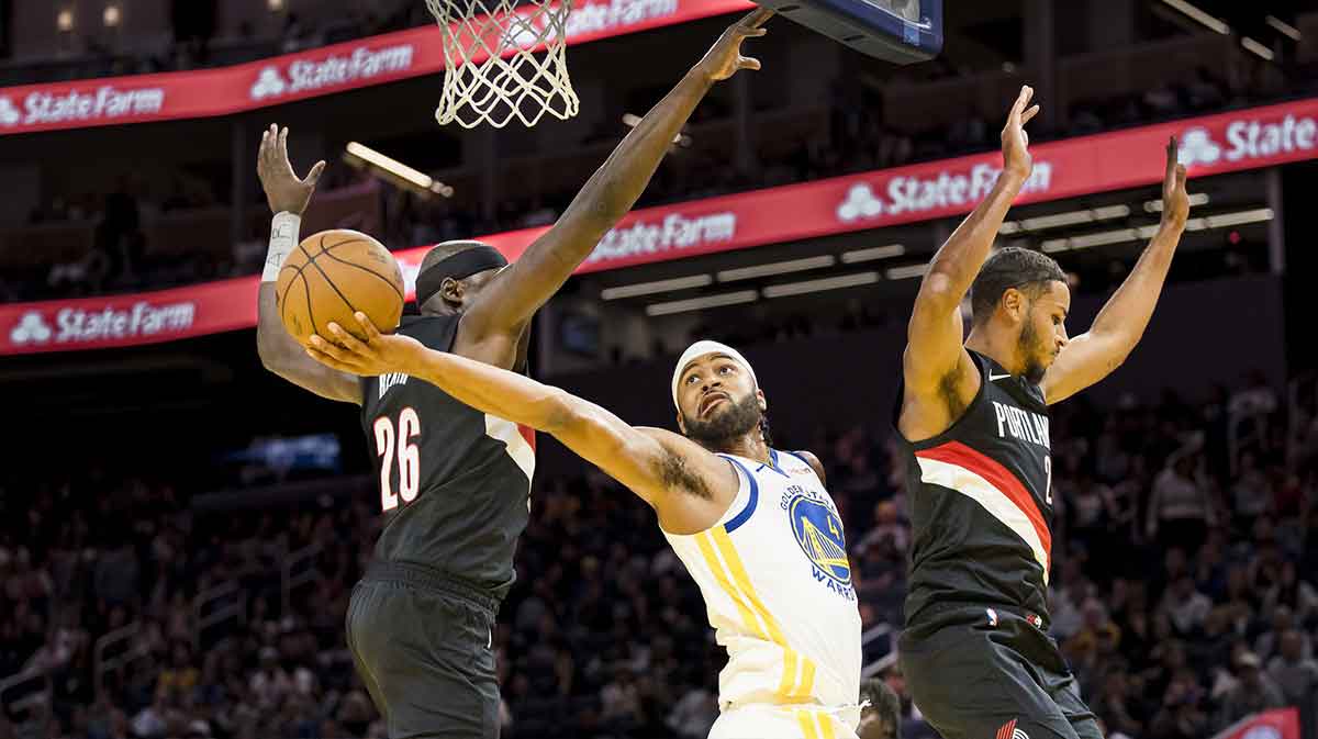 Golden State Warriors guard Moses Moody (4) shoots as Portland Trail Blazers center Duop Reath (26) defends during the third quarter at Chase Center.
