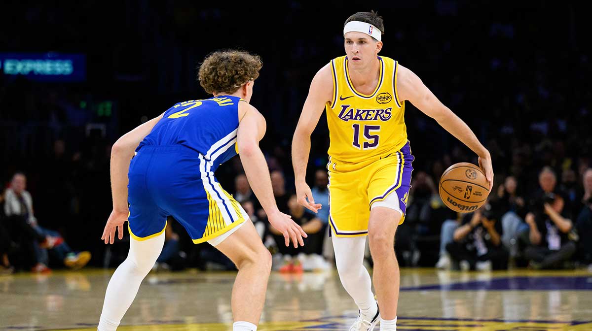 Los Angeles Lakers guard Austin Reaves (15) dribbles against Golden State Warriors guard Brandin Podziemski (2) during the first half at Crypto.com Arena.