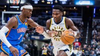 Indiana Pacers guard Bennedict Mathurin (00) dribbles the ball while Oklahoma City Thunder guard Shai Gilgeous-Alexander (2) defends in the second half at Gainbridge Fieldhouse.
