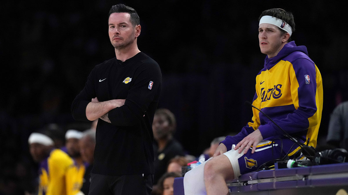 Los Angeles Lakers coach JJ Redick (left) and guard Austin Reaves (15) watch against the Phoenix Suns in the second half at Crypto.com Arena.