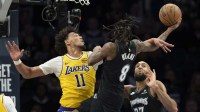 Minnesota Timberwolves guard Bones Hyland (8) drives to the basket as Los Angeles Lakers center Jaxson Hayes (11) plays defense in the second half at Target Center.