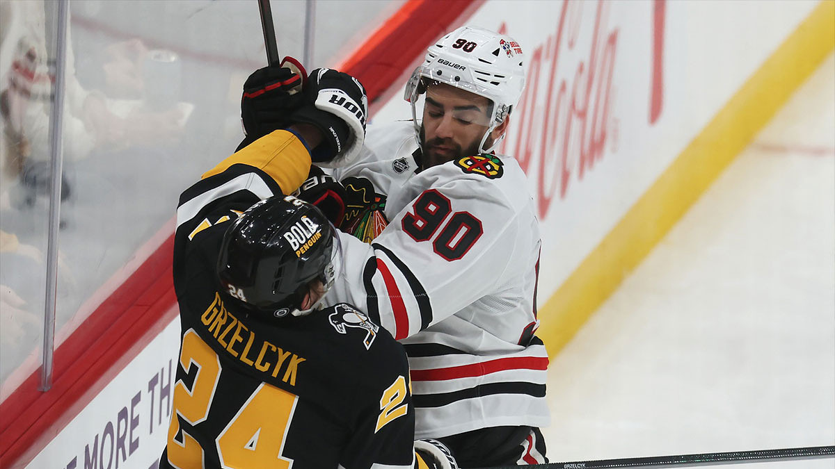 Chicago Blackhawks center Joe Veleno (90) checks Pittsburgh Penguins defenseman Matt Grzelcyk (24)