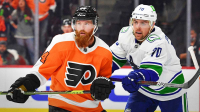 Philadelphia Flyers defenseman Ryan Ellis (94) and Vancouver Canucks left wing Tanner Pearson (70) battle at Wells Fargo Center