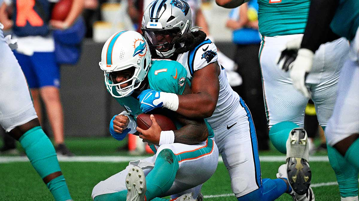 Carolina Panthers linebacker Patrick Jones II (91) sacks Miami Dolphins quarterback Tua Tagovailoa (1) on third down late in the fourth quarter