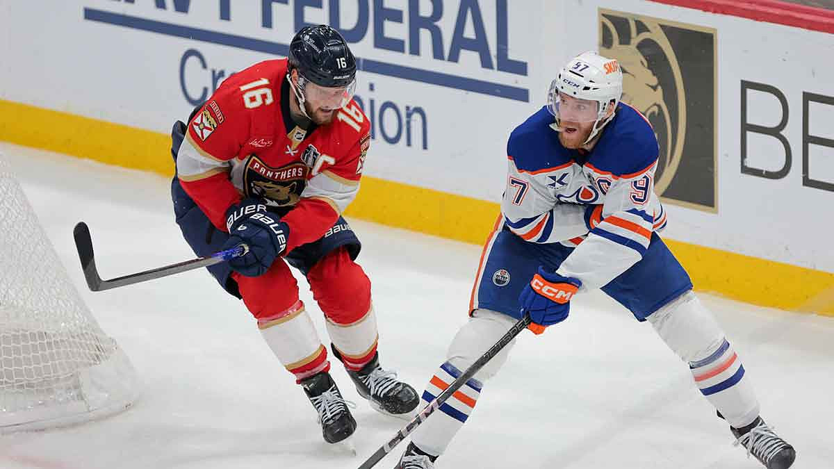 Edmonton Oilers center Connor McDavid (97) passes the puck away from Florida Panthers center Aleksander Barkov (16) during the third period in game six of the 2025 Stanley Cup Final