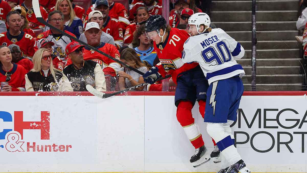 Tampa Bay Lightning defenseman J.J. Moser (90) pushes Florida Panthers center Jesper Boqvist (70) into the boards in the first period during game three of the first round of the 2025 Stanley Cup Playoffs at Amerant Bank Arena.