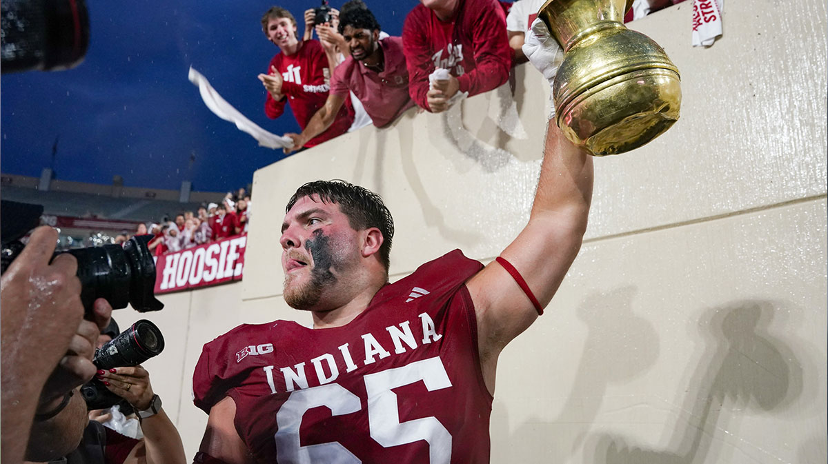 Indiana Hoosiers offensive lineman Carter Smith (65) celebrates with the Old Brass Spittoon after the game against the Michigan State Spartans at Memorial Stadium.