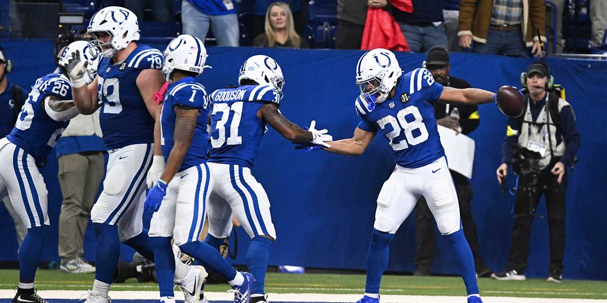 Indianapolis Colts running back Jonathan Taylor (28) celebrates with Indianapolis Colts running back Tyler Goodson (31) after scoring a touchdown during the third quarter against the Tennessee Titans at Lucas Oil Stadium.