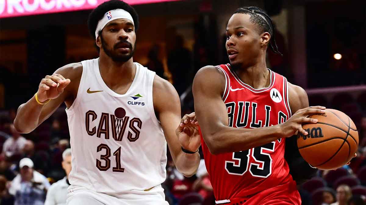 Oct 7, 2025; Cleveland, Ohio, USA; Chicago Bulls guard Isaac Okoro (35) drives to the basket against Cleveland Cavaliers center Jarrett Allen (31) during the second half at Rocket Arena. Mandatory Credit: Ken Blaze-Imagn Images