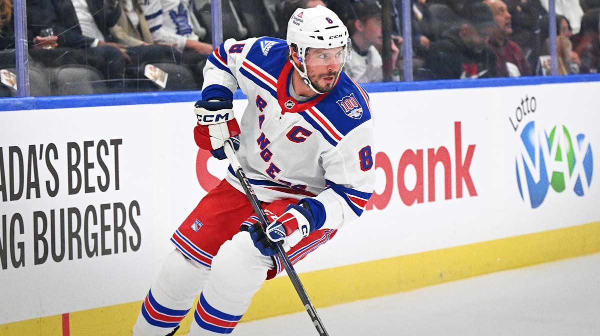 New York Rangers forward J.T. Miller (8) skates with the puck against the Toronto Maple Leafs in the first period at Scotiabank Arena.