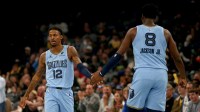 Memphis Grizzlies guard Ja Morant (12) reacts with forward/center Jaren Jackson Jr. (8) during the first quarter against the Los Angeles Lakers at FedExForum.